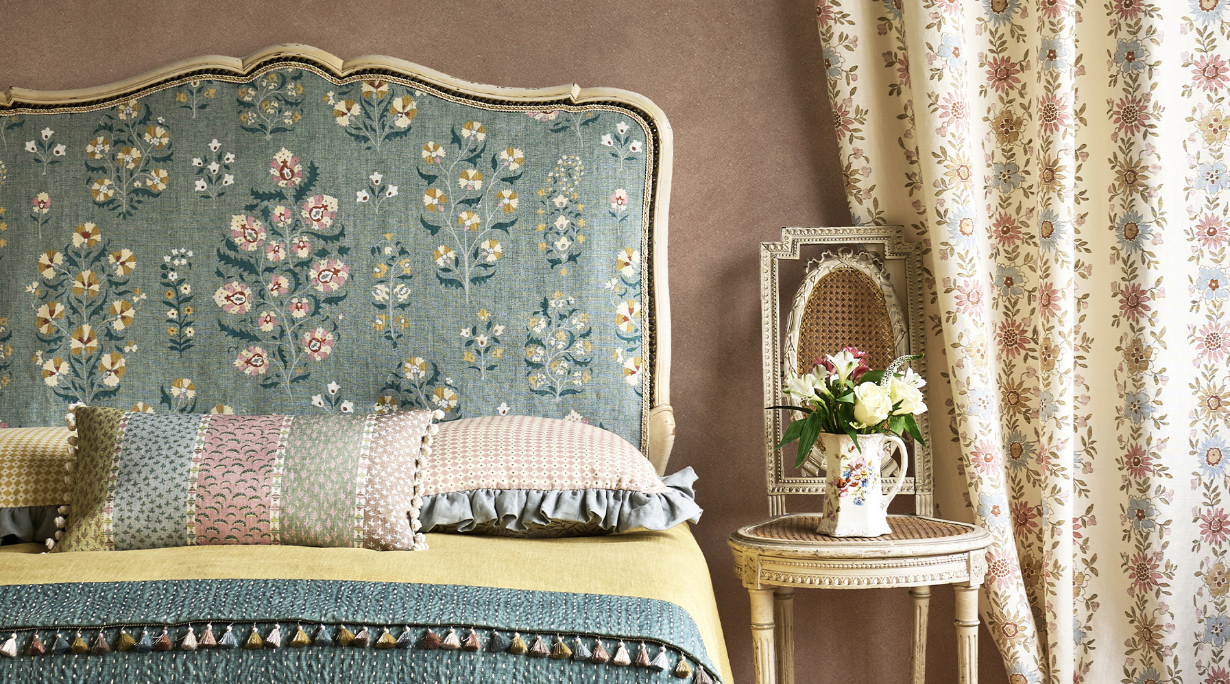Folklora floral bedroom with Lara upholstered bedhead, Freya floral stripe curtain, Asha Stripe cushion with Turner's Texture plaster wallpaper