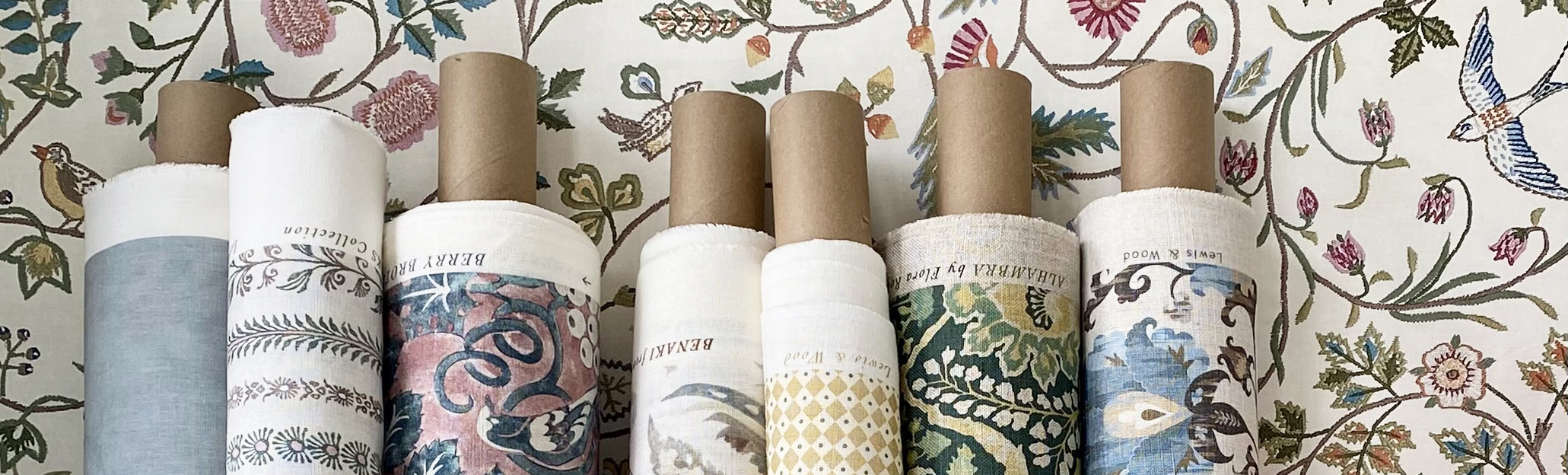 <p>lewis and wood fabric designs on rolls against windrush design wallpaper</p>